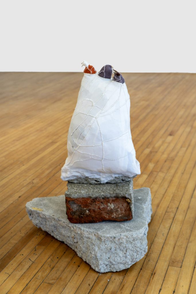 China Adams, Untitled, 2023, 10 freeway concrete, broken glass animals, artists’ scrap (material, clothing, rags), dental floss, 15 in X 10.5 in X 8 in